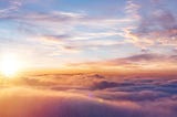 Stock image of sunshine shining over clouds.