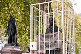 A picture of the Suffragette statue in Parliament square surrounded by fake prison bars