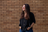 Photo of Lauren Gibaldi standing in front of a brick wall.