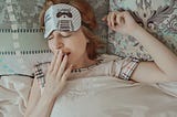 Woman in bed yawning