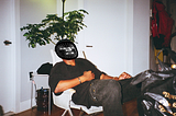 A man leaning back in a chair with several points marking out the geography of his face using Facemesh.