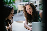 Two women looking at job applications