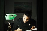 Photo by Dziana Hasanbekava: https://www.pexels.com/photo/thoughtful-man-writing-in-notebook-and-studying-in-home-office-7063764/