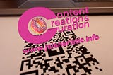 Pink 3D logo hovering above a QR code