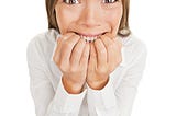 Nervous businesswoman bites her nails nervous about giving a speech