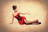 A pin-up briunette in basque and provocative pose, vintage style.