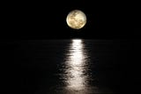 A full moon reflected in the sea