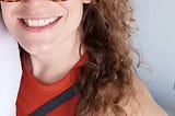 It’s me! A curly-haired, bespectacled woman in an orange top.