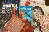 A colorful jumble of magazines and books that I cannot possibly keep up with, including recent issues of The New Yorker, The New Republic, The Atlantic, The New York Review of Books, ACLU Magazine, “Imperial,” a book of poetry by George Bilgere, and “To the Lighthouse,” by Virginia Woolf. (Photo by author.)