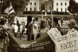 NAPAWF DC chapter holds a banner in protest of deportation raids in front of the White House in 2009.