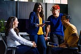 A leader sharing valuable communications during a team meeting where three team members are joining the discussion.