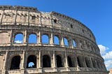 Ancient Roman Colosseum against a brilliant blue sky