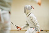 Womand fencing and holding a sword