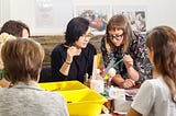 A group of artists at the firebird workshop discuss a new nesting doll design.