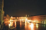 A look at one of Venice’s famous canals at night, lit up by varied lights and lanterns, from the rooftop of the Foscari Palace.