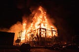 World famous image of Minneapolis police department’s 3rd Precinct building being burned down.
