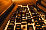Backlit computer keyboard glowing amber