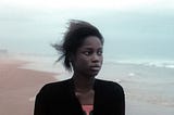 Mama Sáne as Ade in Atlantiques, on a beach looking out to sea