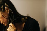 Self-portrait of a girl with flower branches in her hands close to one of her ear— Still life photographer Bozen, Italy