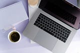 A laptop and a coffee mug on adesk