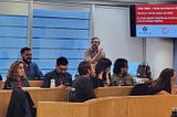 A presenter gives a talk to a room of digital rights advocates.