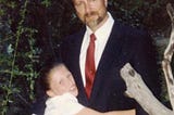 Picture of Dr. Robert Reid with his daughter hugging him.