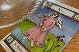 The Temperance tarot card nex to an empty glass jar