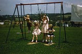 Children playing on a swing set