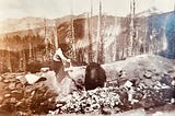 Young woman coaxing a bear with bacon in 1920