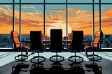 A conference room with a desk and empty chairs in front of large windows with a cityscape in the background