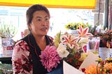 The Face Behind the Flowers at Pike Place