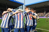 Sheffield Wednesday players huddle and celebrate following a victory at the Hillsborough Stadium.