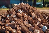 Pile of dirt with unpolished diamonds