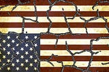 Upside down, antique-looking American flag with cracks — distress and division
