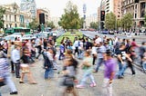 Photo of a crowd of people walking a city street in Chile.