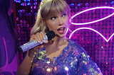 Taylor swift in a sparkly dress on a cool purple light background — with a bedazzled microphone.