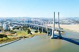 An aerial view of the Vasco da Gama Bridge in Lisbon, Portugal, including the neighbouring park.