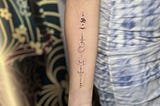 Symbolic moon line tattoo