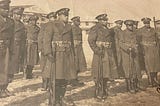 Photo of Soldiers from the 92nd Infantry Division, standing in formation in Korea on the icy frozen ground. Photo is from the author’s personal collection and of his grandfather, from left to right, 4th person, front row.