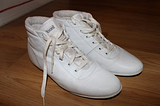 A pair of vintage white “baloons” brand sneakers