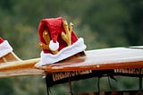A Santa hat on a surf board illustrating the experience of Christmas in New Zealand.