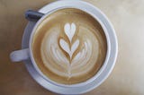 A cup of coffee with a latte art in it for the blog of The Art of Brewing: A Guide to Different Coffee Brewing Methods