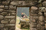 white guy sitting at Machu Picchu