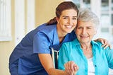 a professional caregiver from one of the trusted in-home care agencies with her elderly female patient