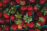 Baskets of very ripe, bright red strawberries