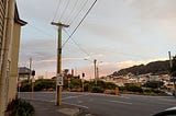 A sunset over Kent Terrace on the entrance to the Arras Tunnel. A sign in the foreground has an image of a bike and reads “use ramp”.