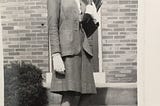 Young woman dressed nicely standing on door steps