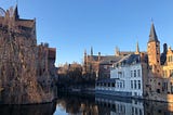 A row of old houses and mini castles overlooking a canal