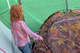young girl entering her family’s tent