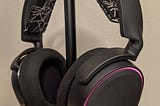 Side view of the Arctis 5 Headset with pink lights around the edge.